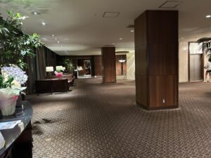 Sheraton Miyako Hotel Tokyo a room with a large wall and a large table and chairs