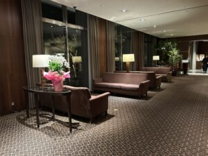 Sheraton Miyako Hotel Tokyo a room with couches and a vase of flowers