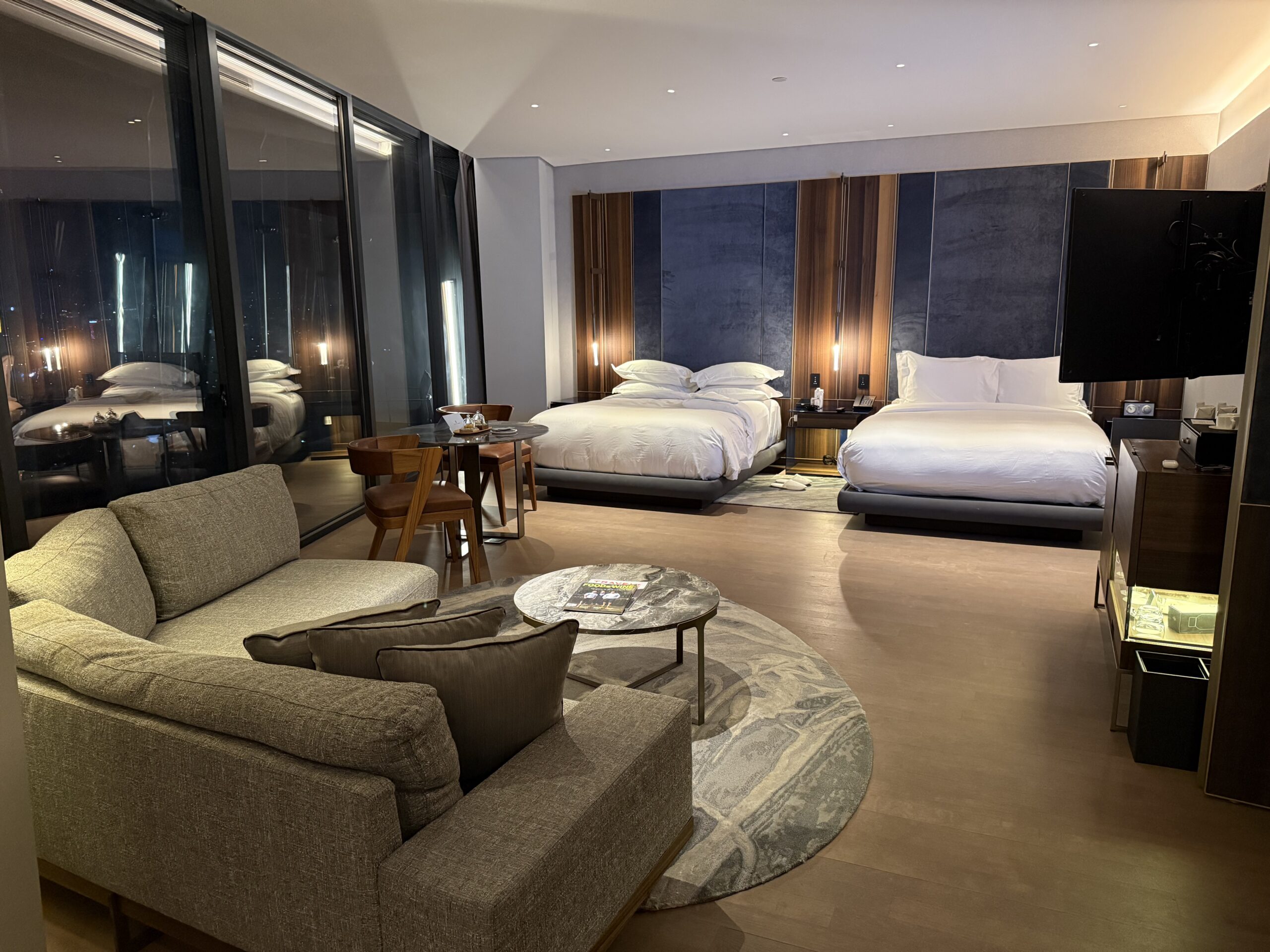 a room with two beds and a table