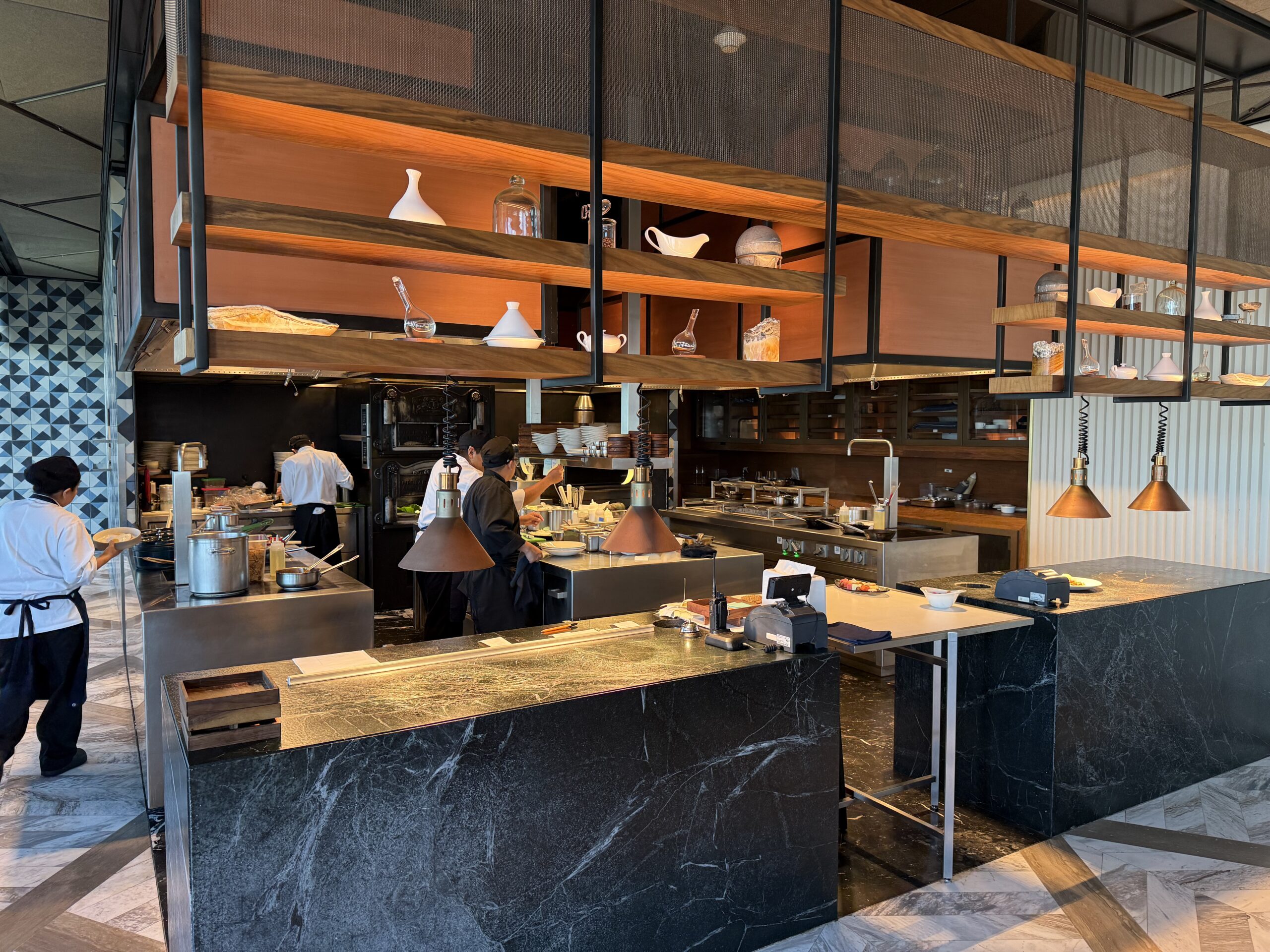 a kitchen with a large counter and a large staircase