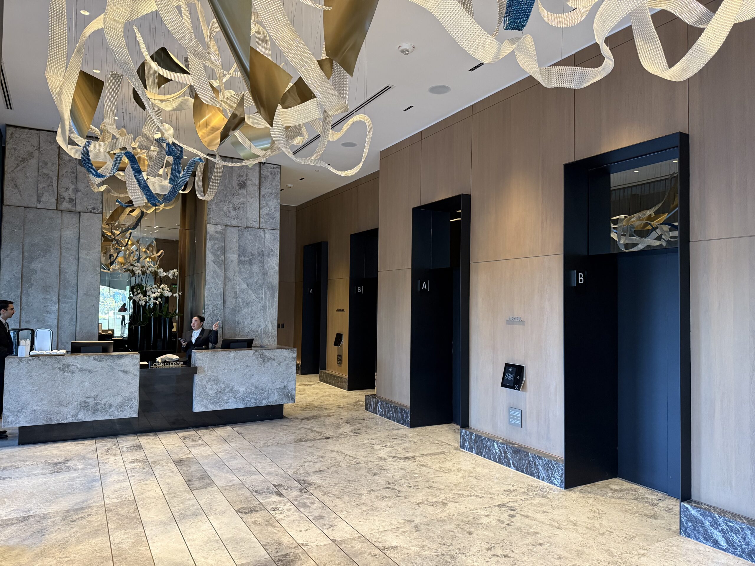 a lobby with a counter and a chandelier