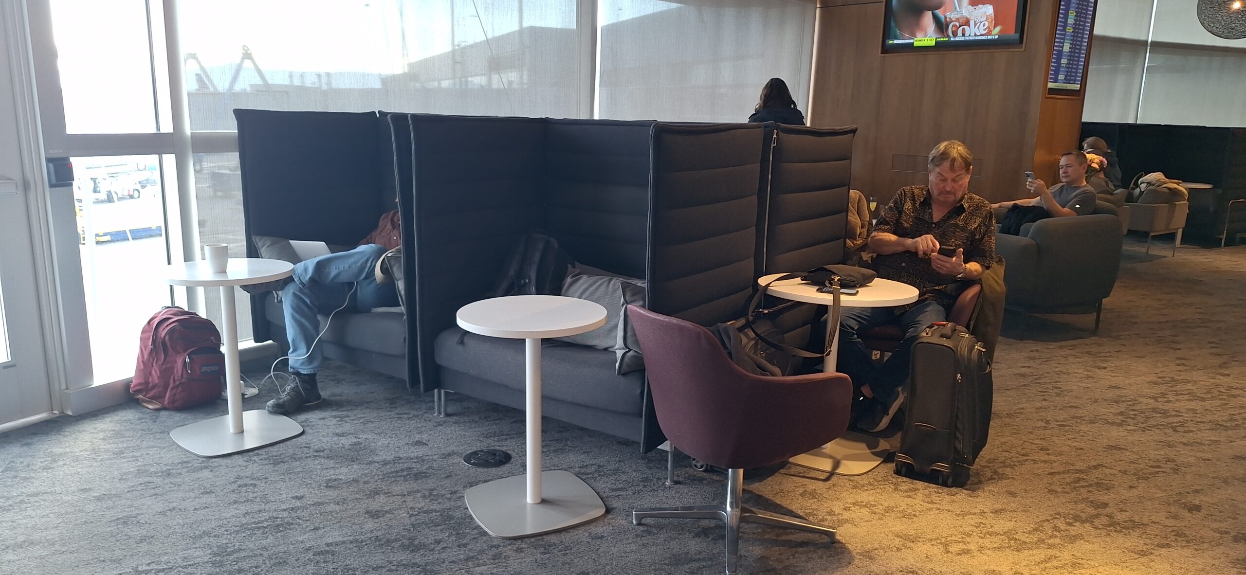 Centurion Lounge Las Vegas a group of people sitting in a room with chairs and tables