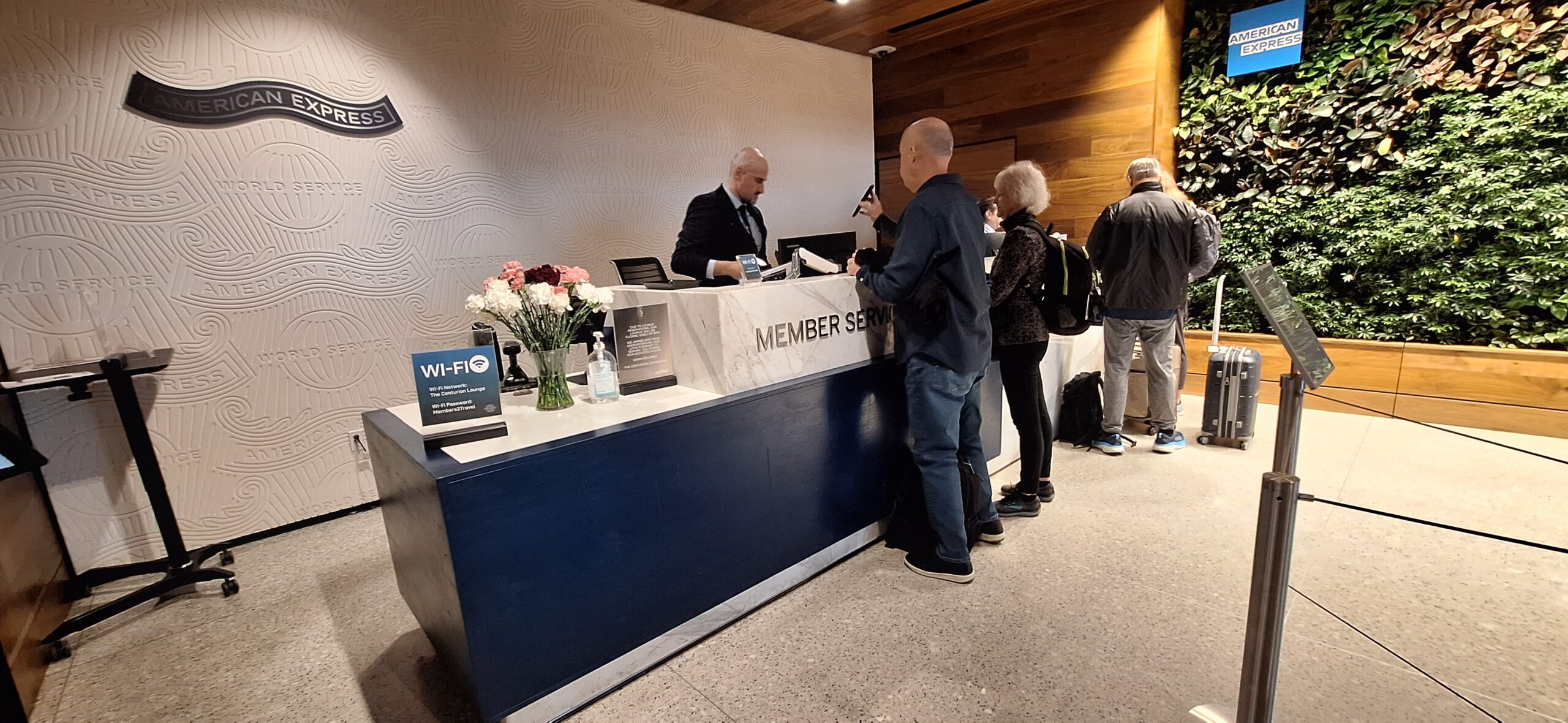 Centurion Lounge Las Vegas a group of people standing at a reception desk