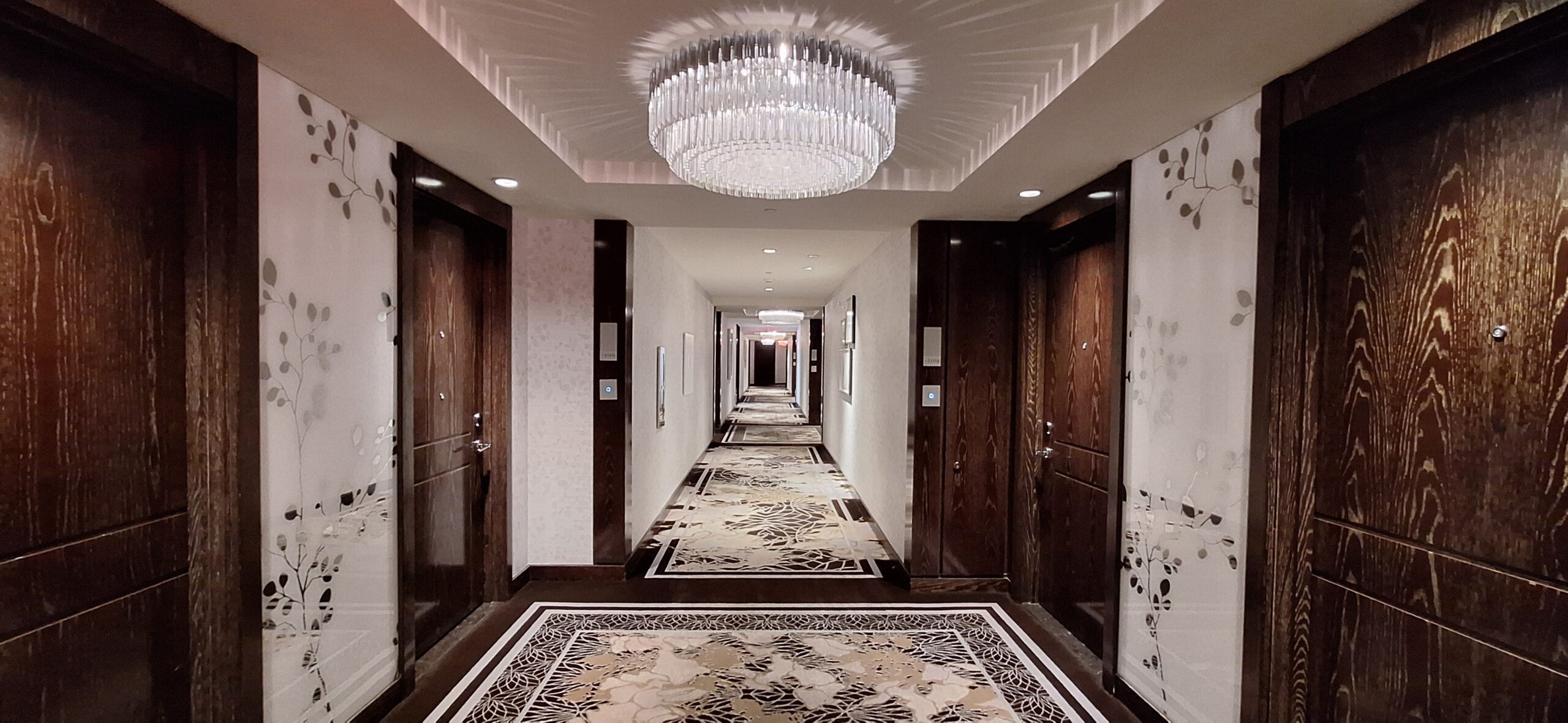 a long hallway with a chandelier