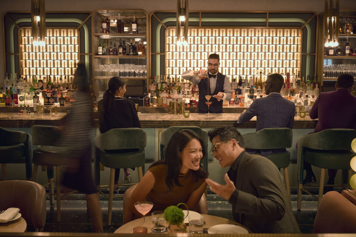 a group of people sitting at a table in a bar