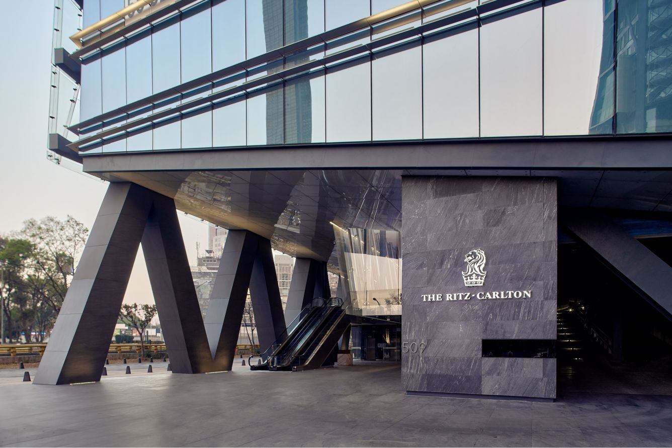 a building with a glass wall and a sign