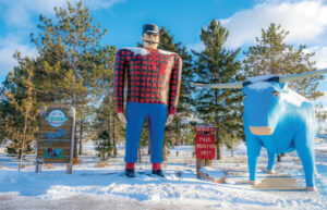 a large statue of a man and a bull in the snow