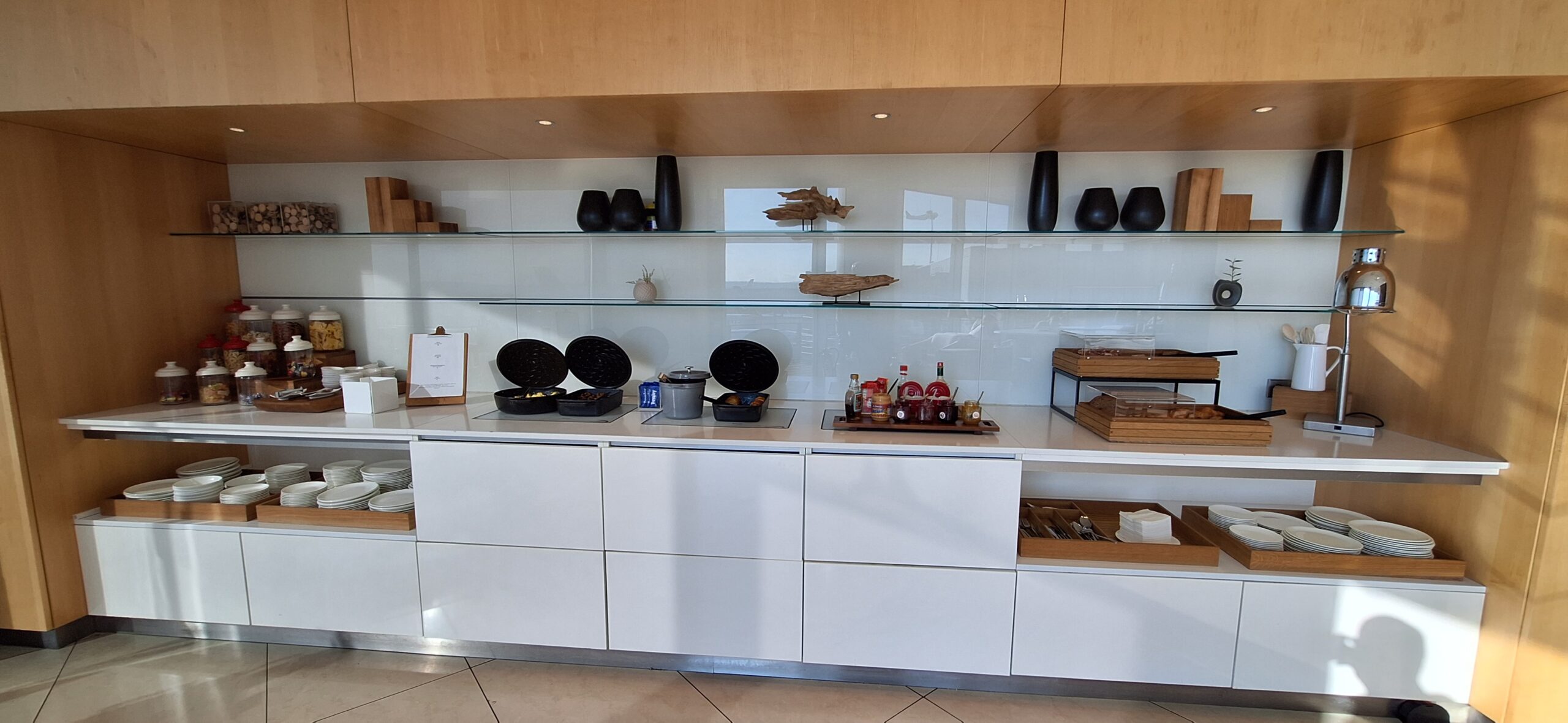 a kitchen with glass shelves