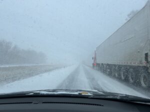 a truck driving on a snowy road