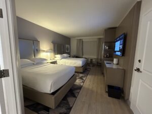 a room with two beds and a tv