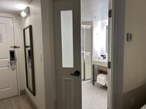 a door with a mirror in the middle of the room