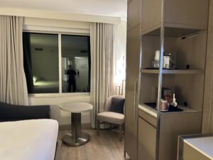 a room with a bed and a table and a shelf