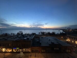 a building with a body of water in the background