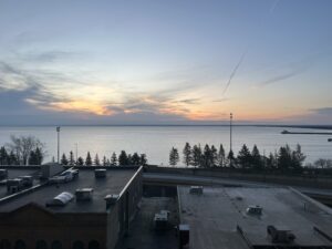 a rooftops of buildings and a body of water