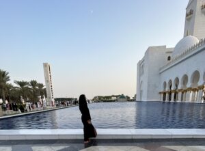 a woman standing next to a pool of water