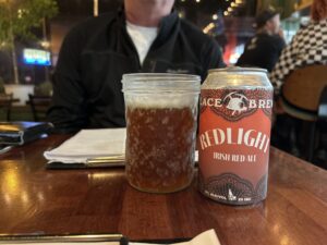a can and glass of beer on a table