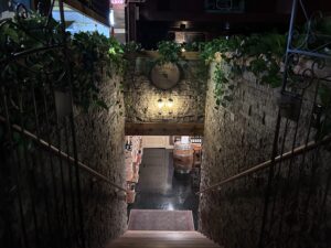 a staircase leading to a wine cellar