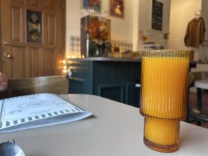 a glass of orange juice on a table