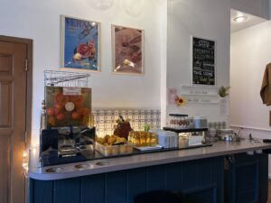 a counter with a variety of fruits and drinks on it