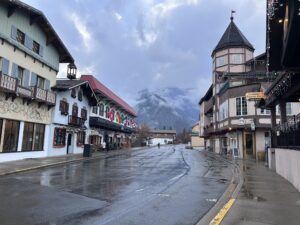 a street with buildings and mountains in the background