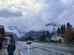 a road with cars and buildings in the background