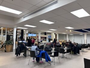 a group of people sitting at tables in a large room