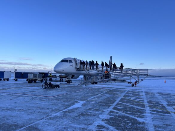 a group of people standing on a plane