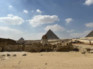 a group of people standing in front of a pyramid