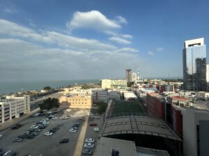 a city with cars parked in front of the water