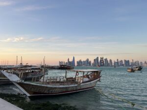 boats on the water with a city in the background