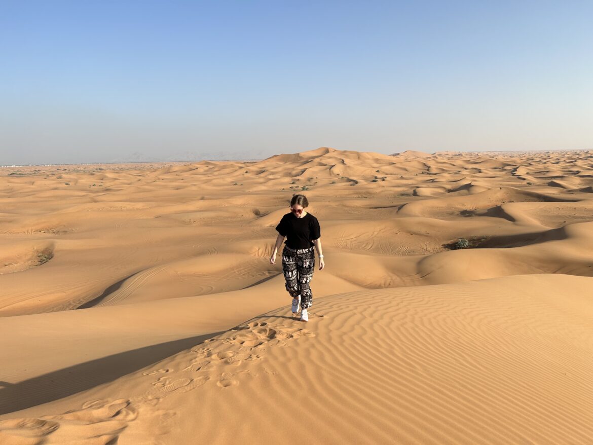 a woman walking in a desert
