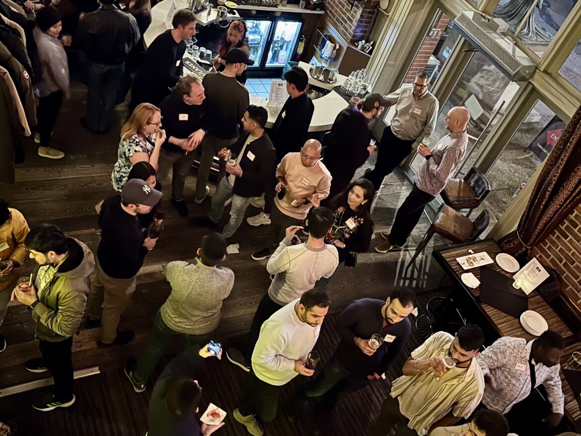 a group of people standing around a table