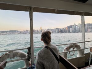 a woman looking out a window at a city