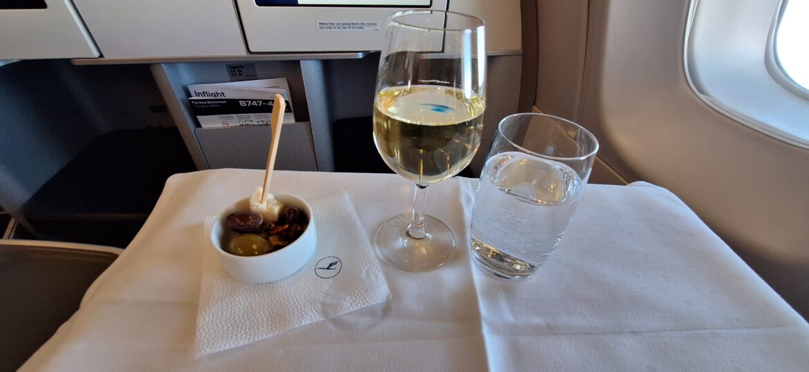 a glass of wine and a bowl of water on a table