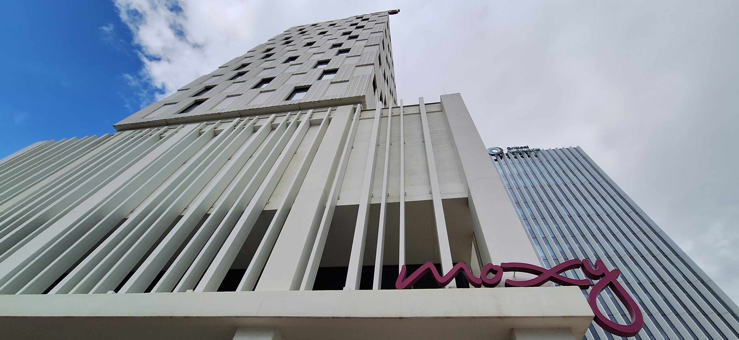 a tall building with a purple sign