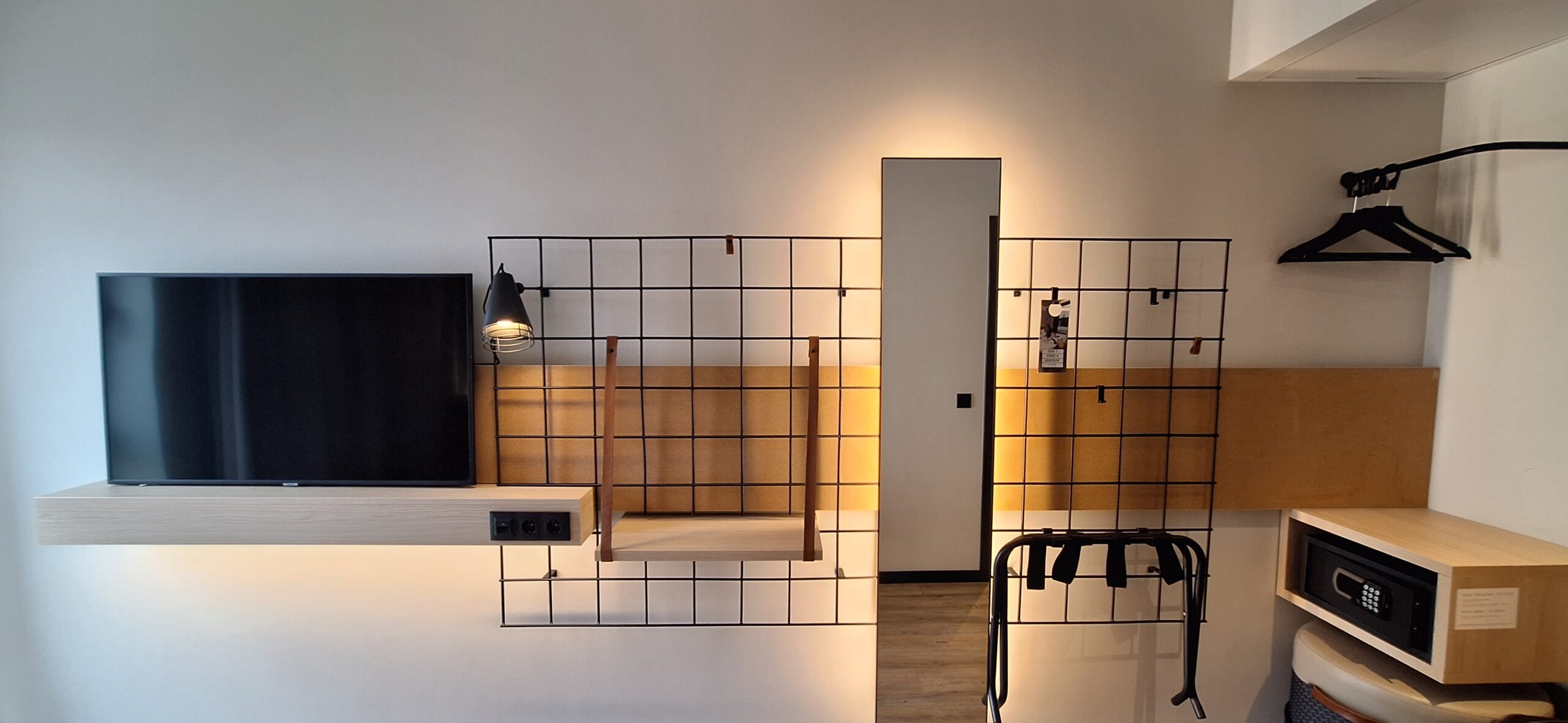 a room with a tv and a grid wall