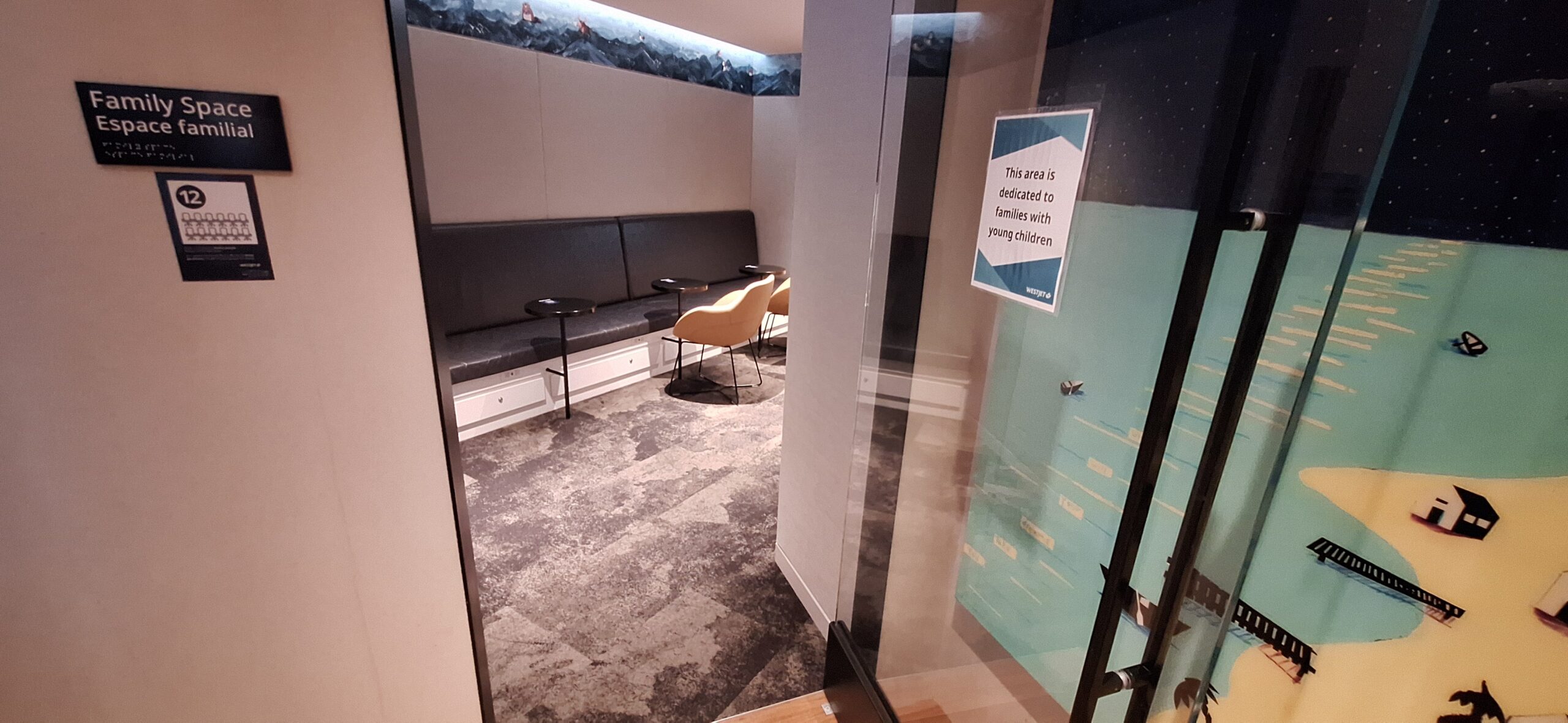 a room with a glass door and a couch