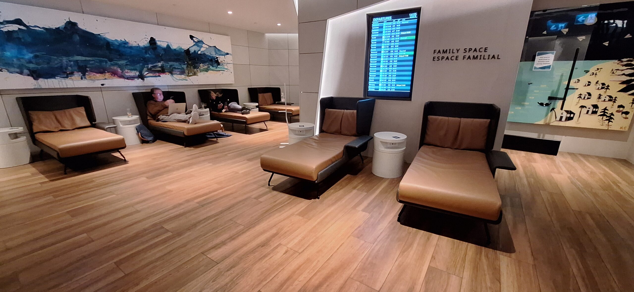 a room with lounge chairs and a screen