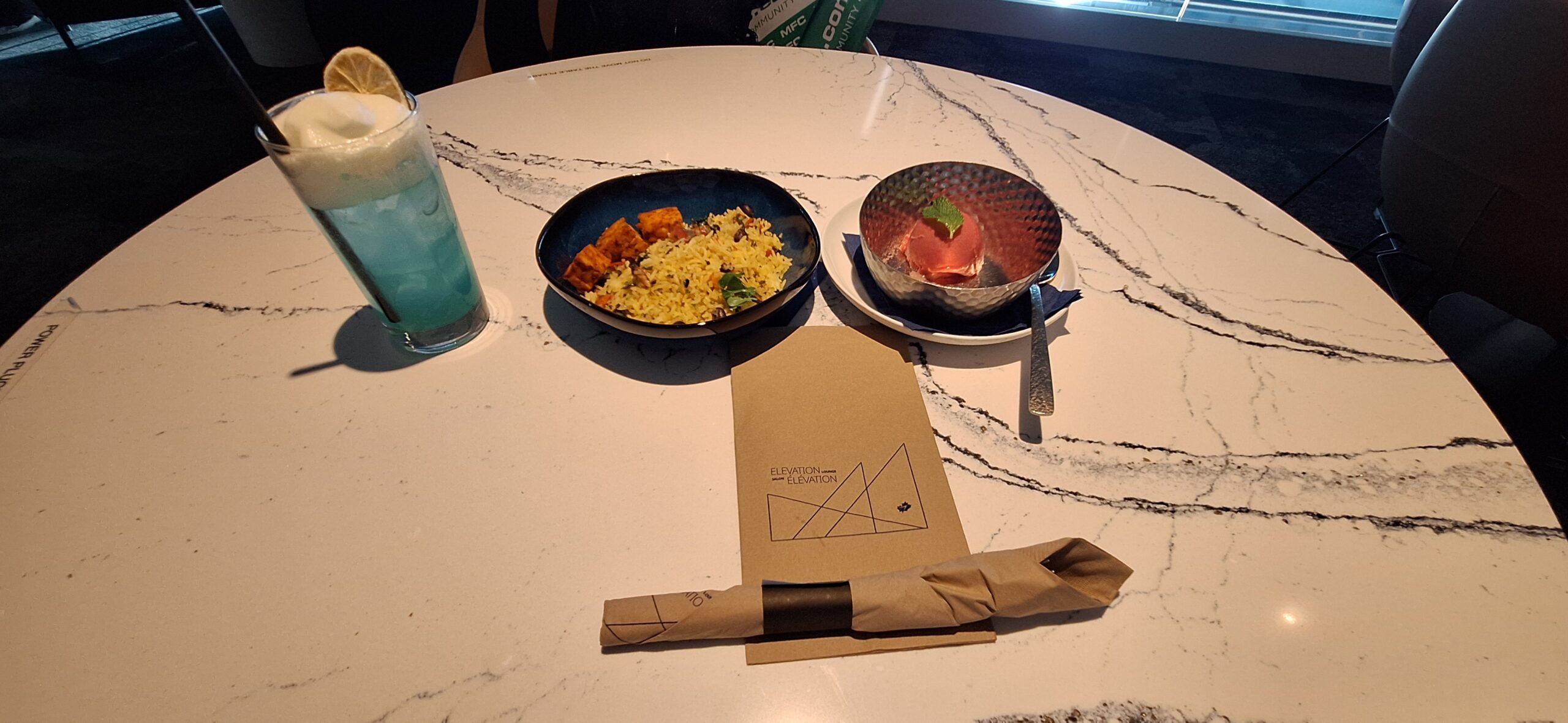 a plate of rice and a bowl of food on a table