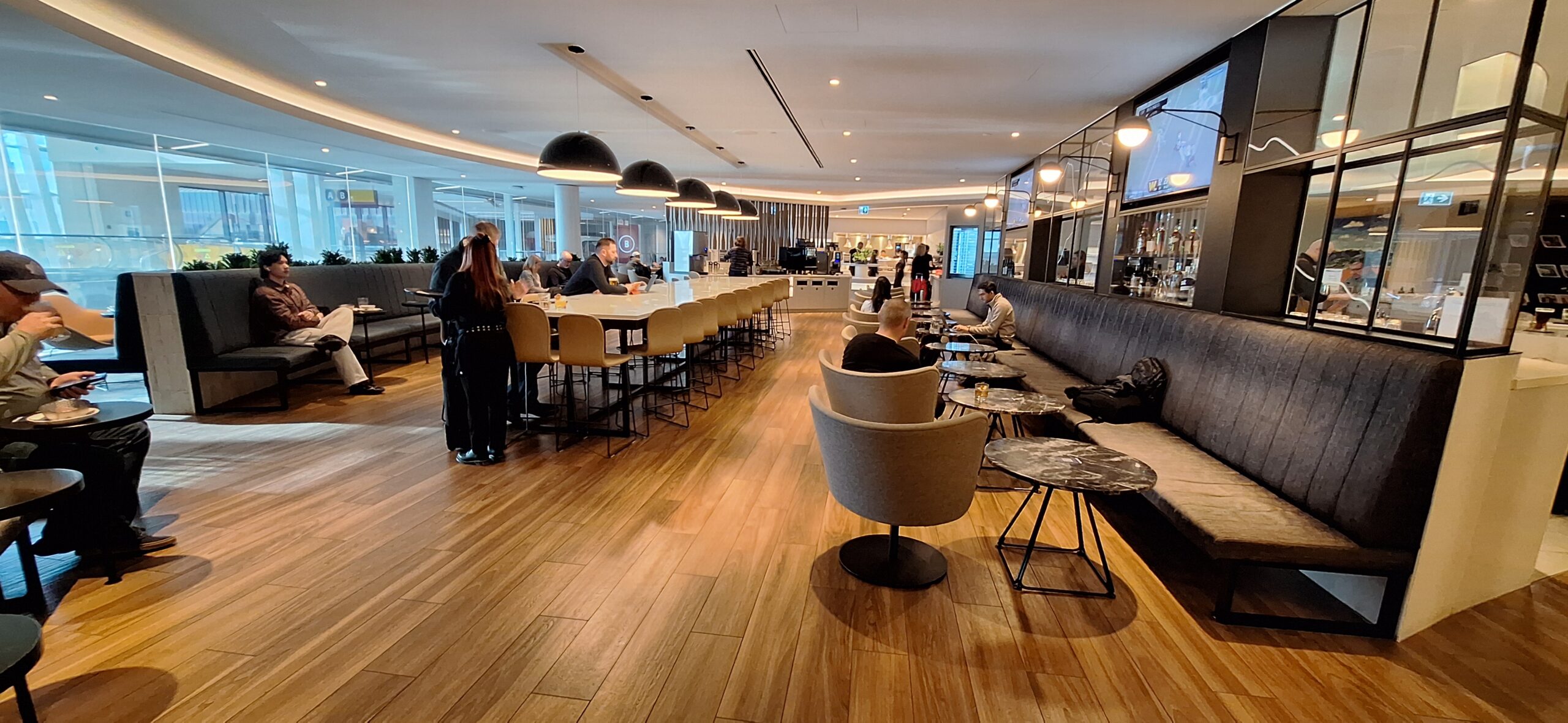 a group of people sitting at tables in a restaurant