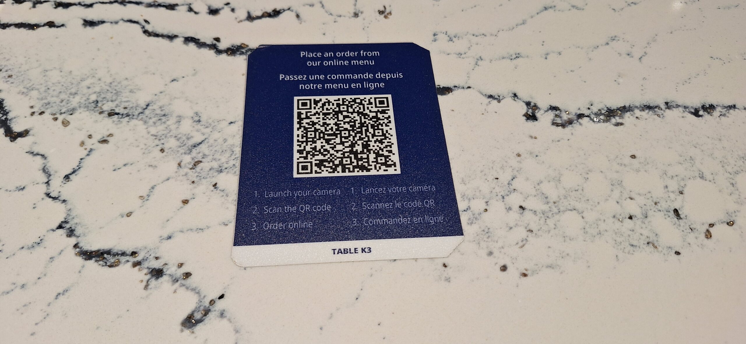 a blue and white card with a qr code on it