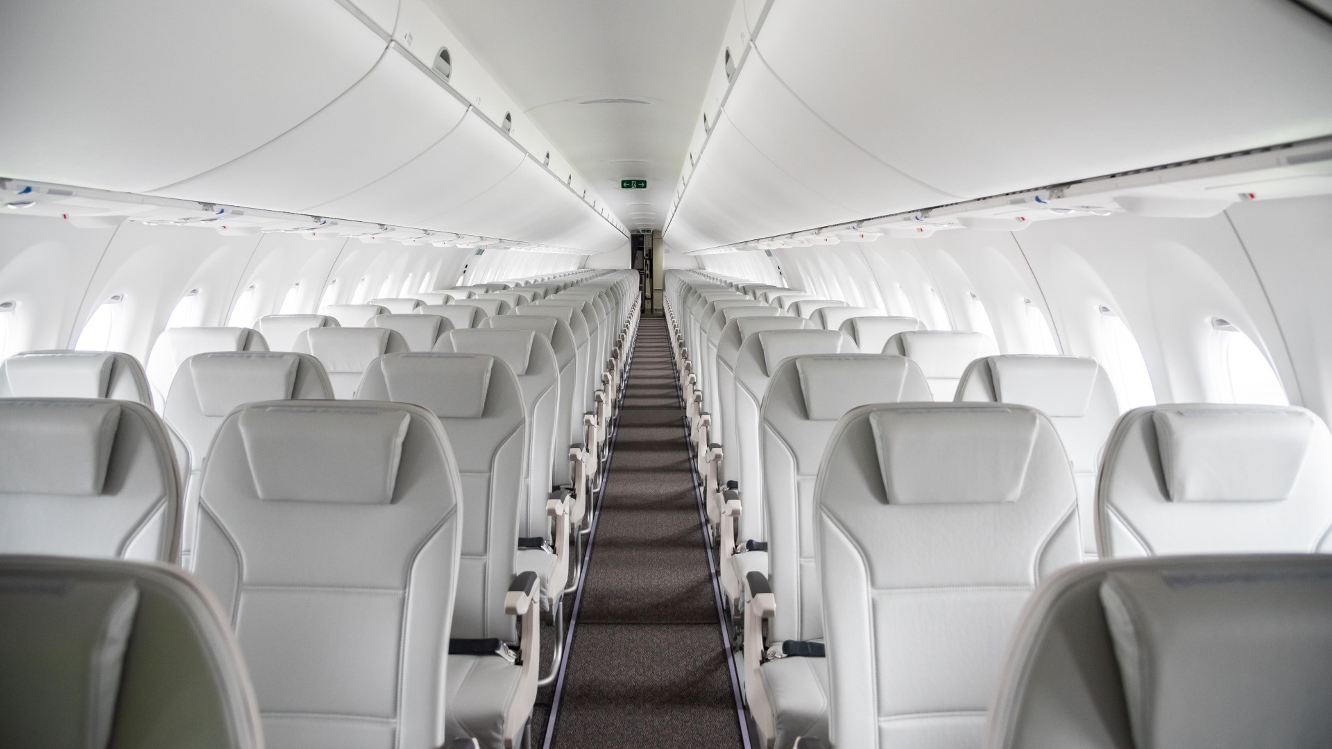 Aeroplan airBaltic partnership a row of white seats in an airplane
