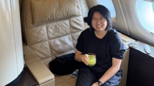 a woman sitting on a chair holding a drink