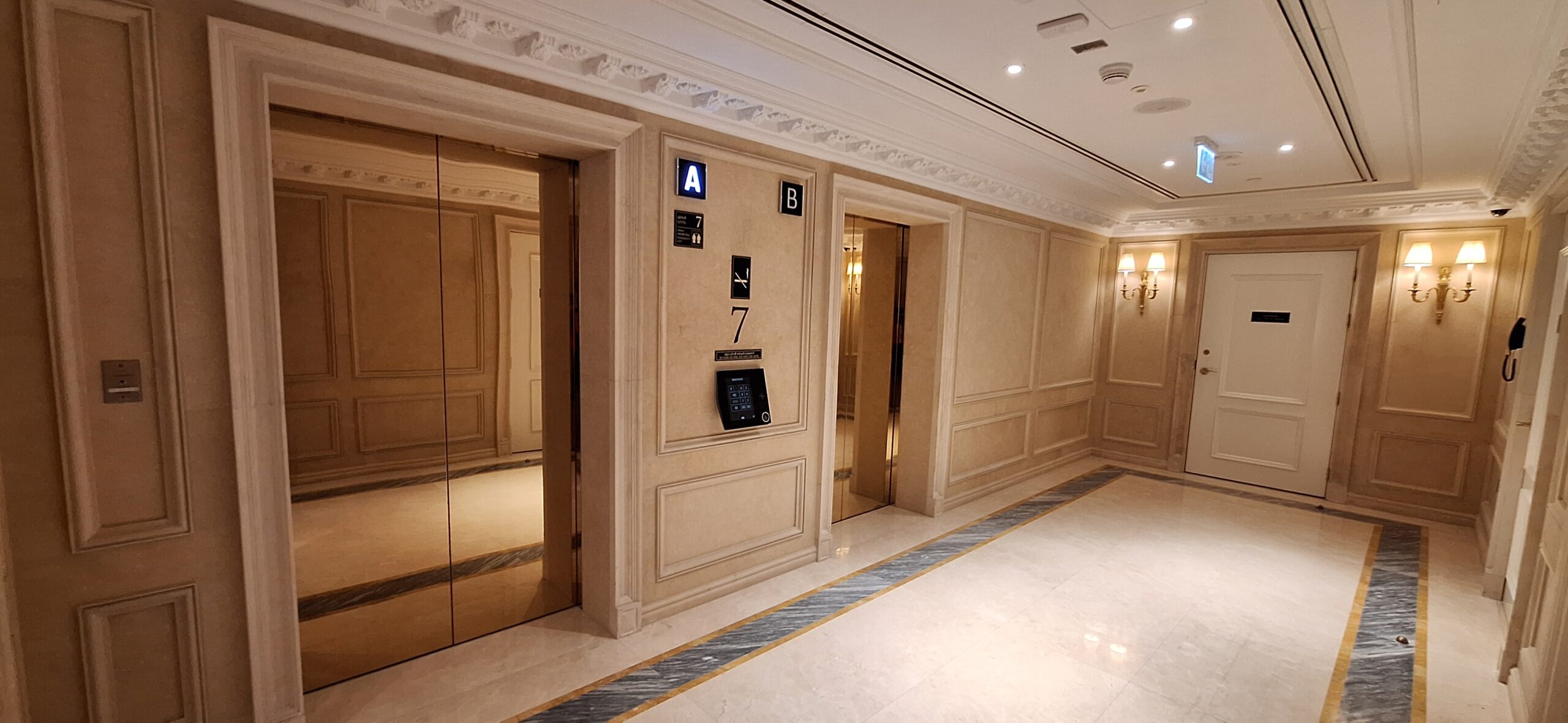 a hallway with elevators and signs