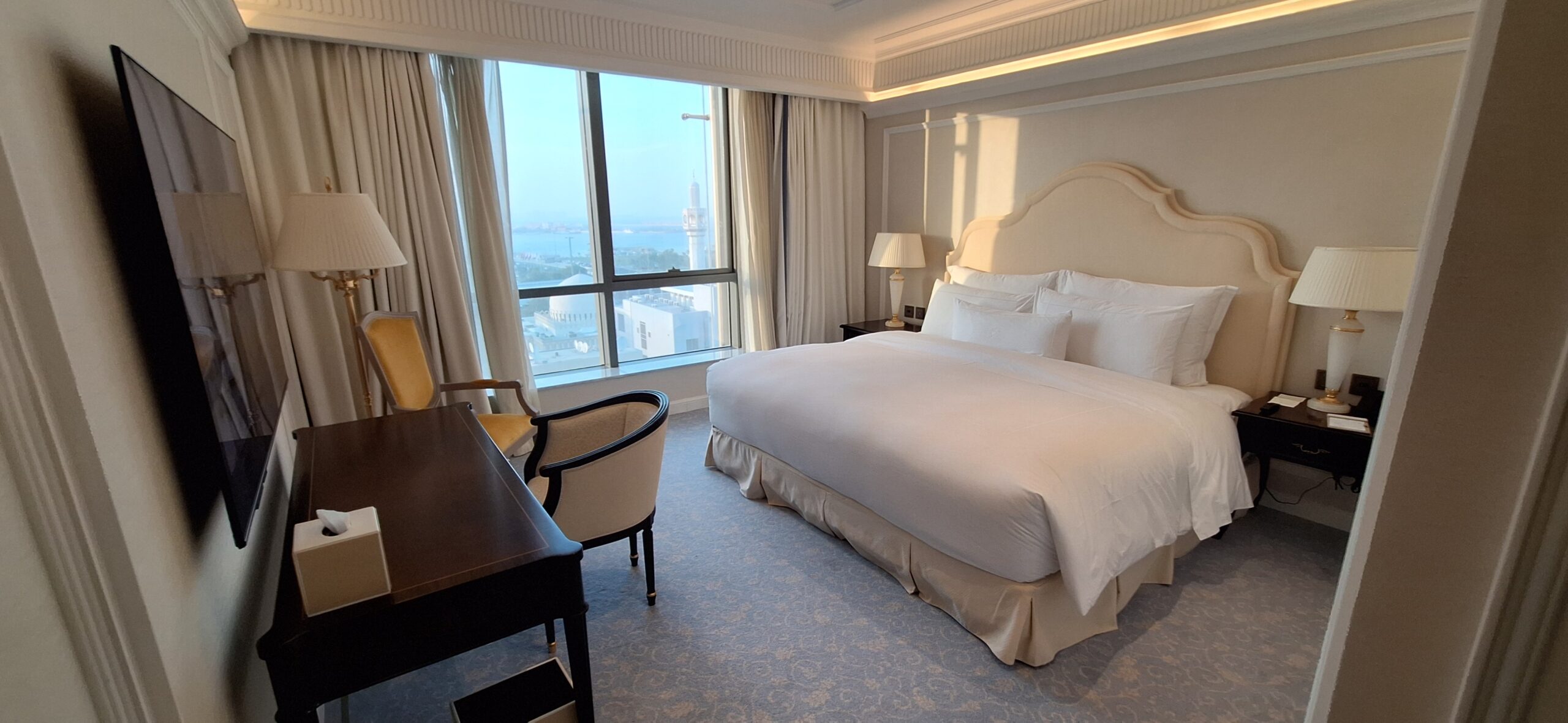 a bedroom with a desk and a bed