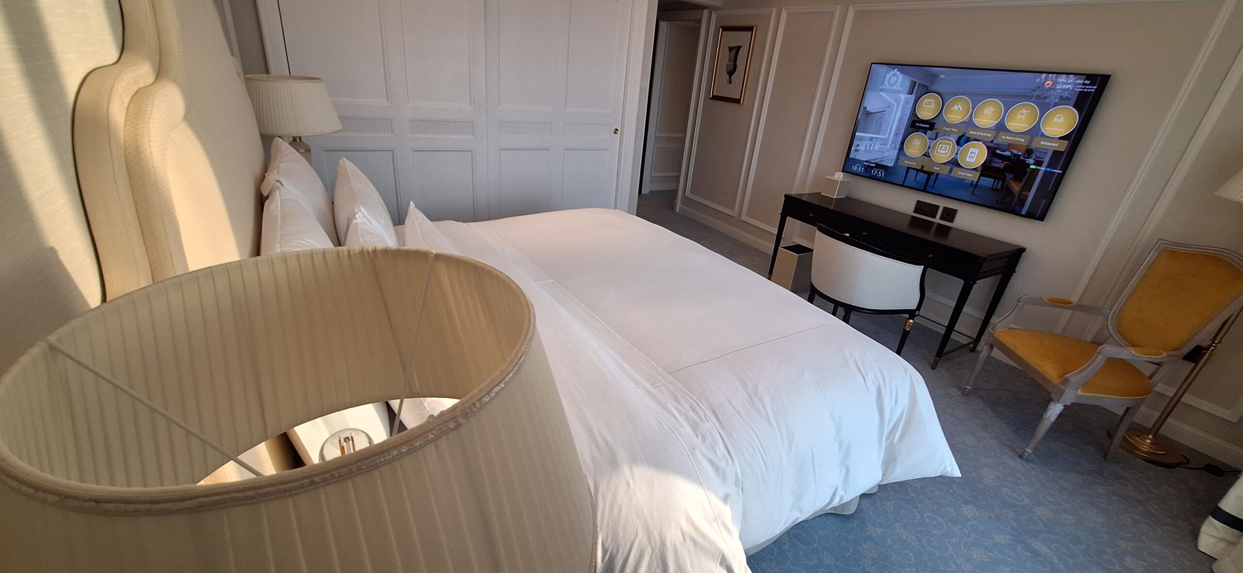 a bed with a lamp and a television