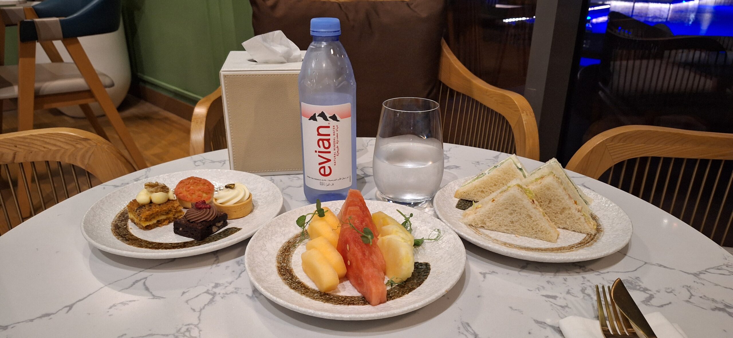 a plate of food and a bottle of water on a table