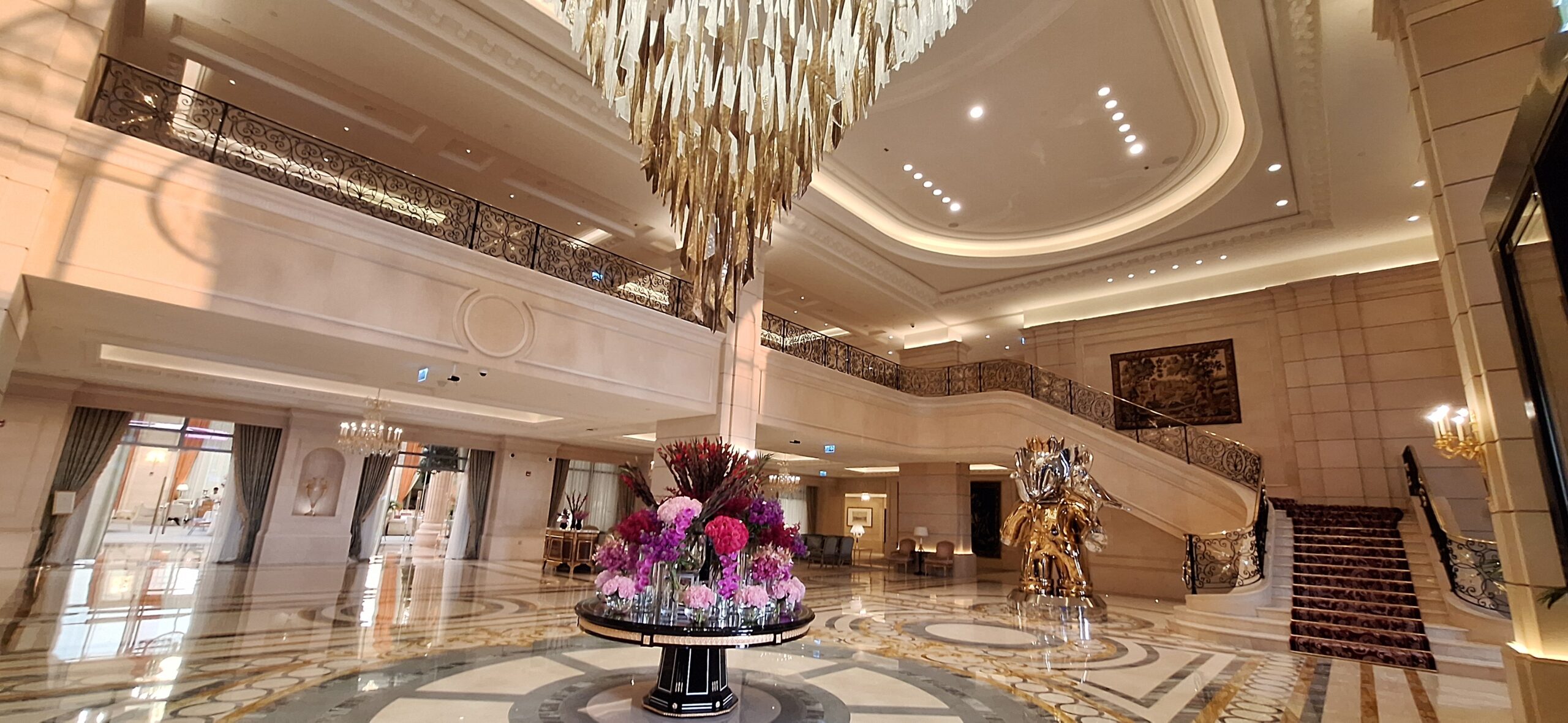 a large hall with a large chandelier and flowers