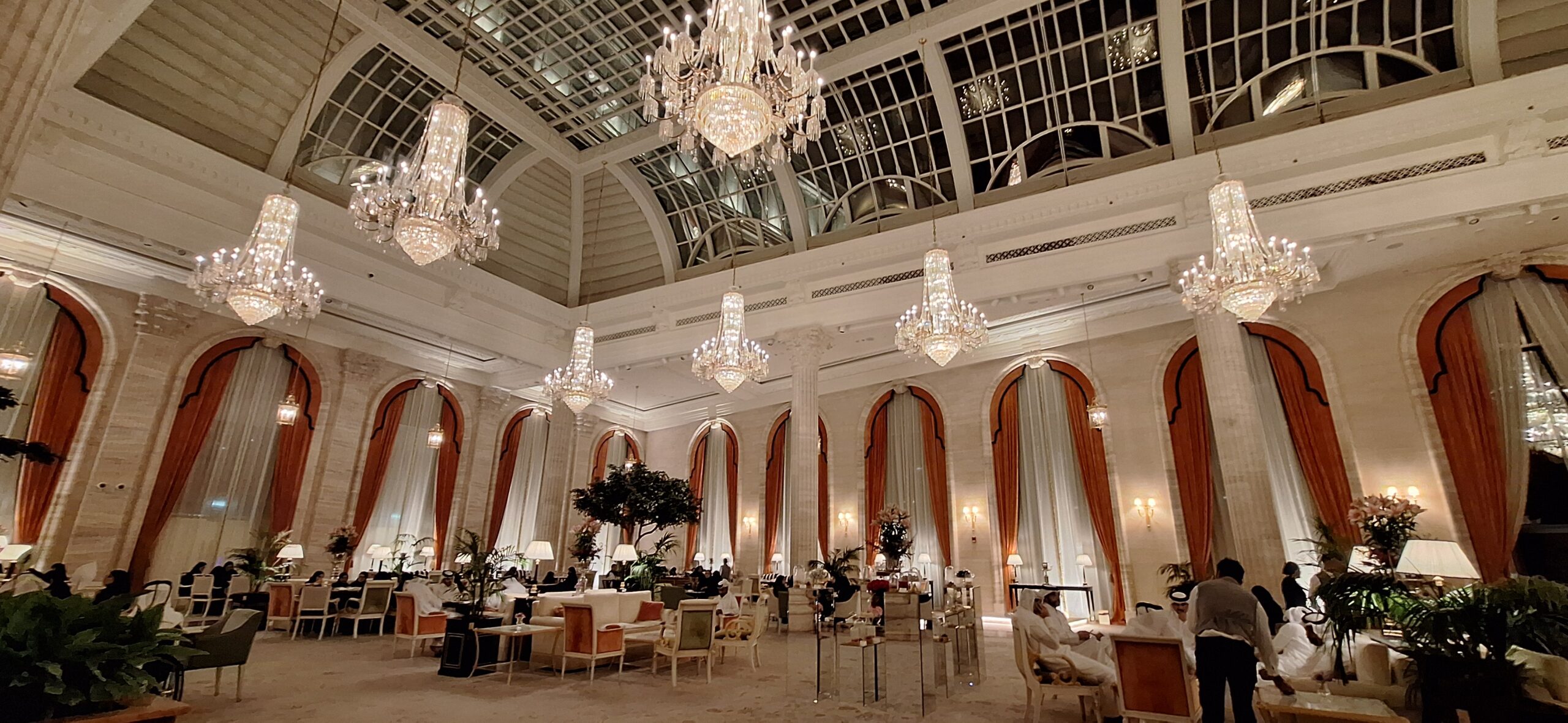 a large room with chandeliers and tables