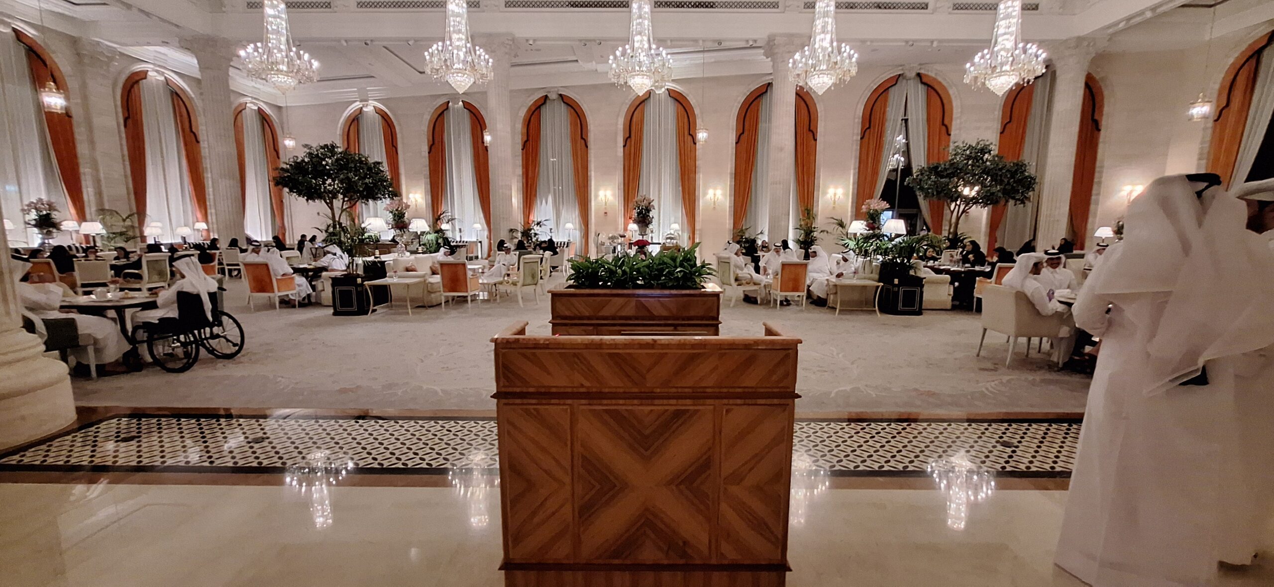 a room with a large chandelier and a podium